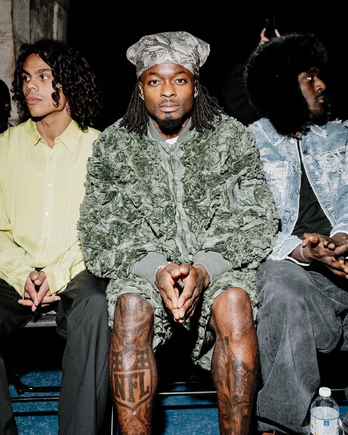 Marquise Goodwin front row at the Taakk runway show during Paris Fashion Week, dressed in full Taakk
